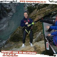 Canyon swing souvenir photo of a man in a harness above a river gorge